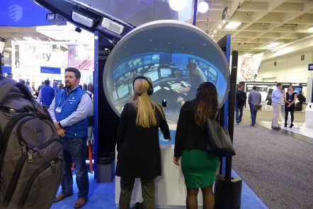 Picture of two event attendees using an immersive 360 Mini Dome with a cyber security experience at Brand Activations at IBM Think Las Vegas